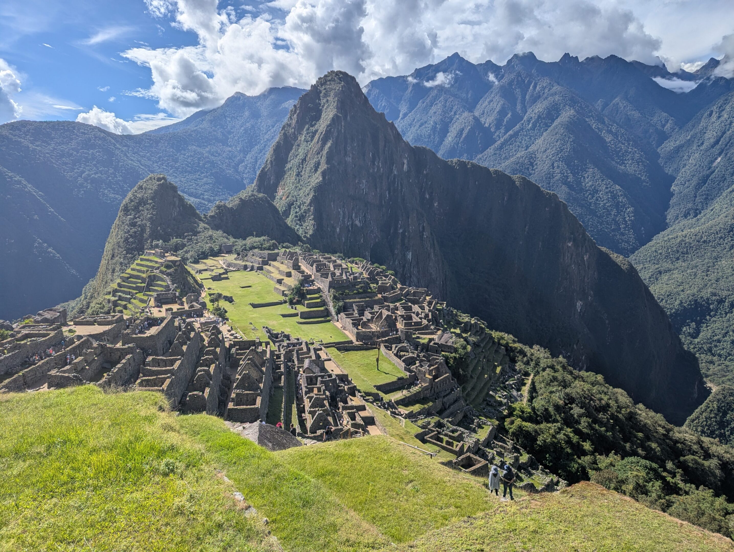 Machu Picchu ruins with surrounding mountain landscape.